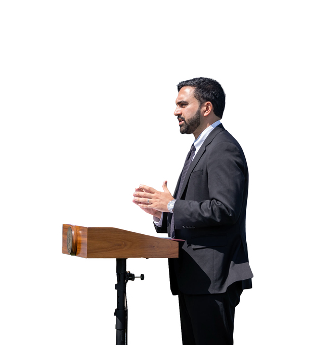 Zohran Mamdani speaking at a podium